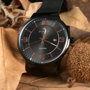 Luxurious analog watch photographed on a bed of autumn leaves, showcasing elegance.