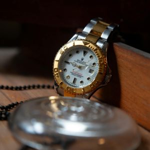 Close-up of a luxury Rolex wristwatch with gold and silver detailing, symbolizing elegance and precision.