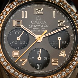 Close-up of a luxurious Omega Speedmaster watch with diamond bezel and chronograph features.