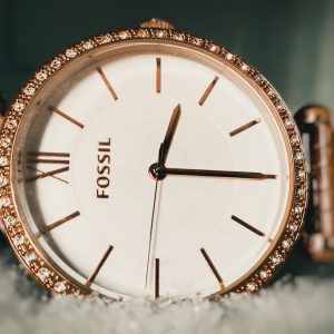 Close-up of an elegant Fossil wristwatch with a gold bezel and sparkling details, captured in Armoor, India.