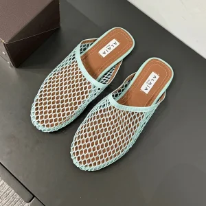 ALAIA FLAT MULES IN LIGHT BLUE MESH FISHNET