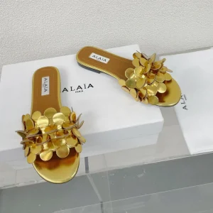 ALAIA FLAT MULE IN GOLDEN GLOSSY LAMBSKIN