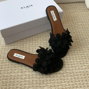 ALAIA FLAT MULE IN BLACK SUEDE